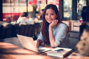 Woman on laptop in a cafe.